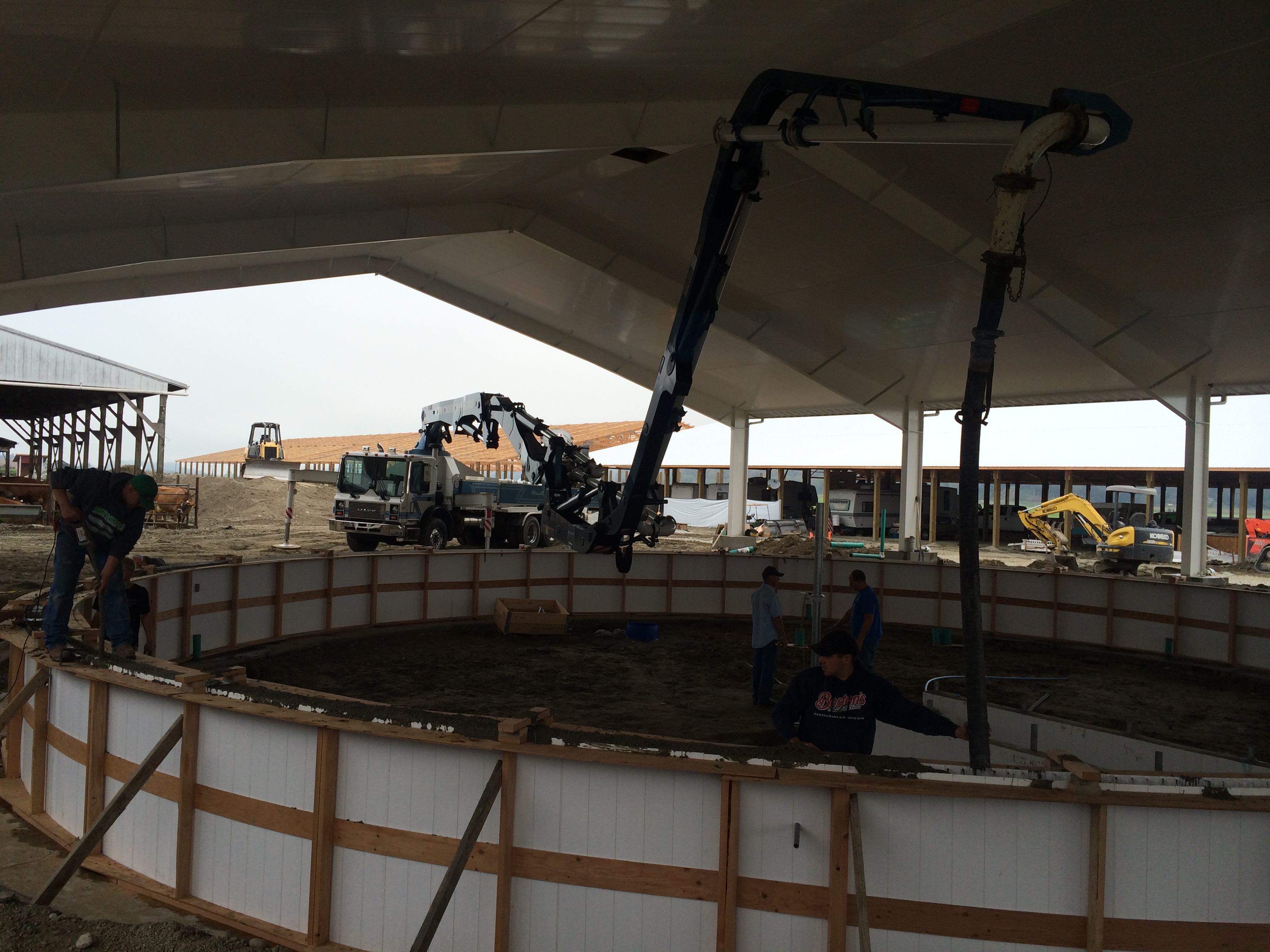 32 Z Boom reaching over the milking carousel to pour circular wall in Stanwood, WA. 