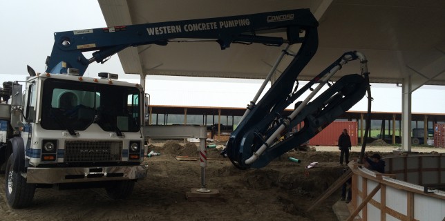 32 Z Boom is scrunched up to pour walls for a new milking carousel.